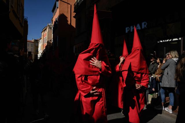 Penitants wearing caperuxta hoods take part in the Procession de la Sanch (Procession of Blood) in Perpignan on April 3, 2026. (Photo by Ed JONES / AFP)