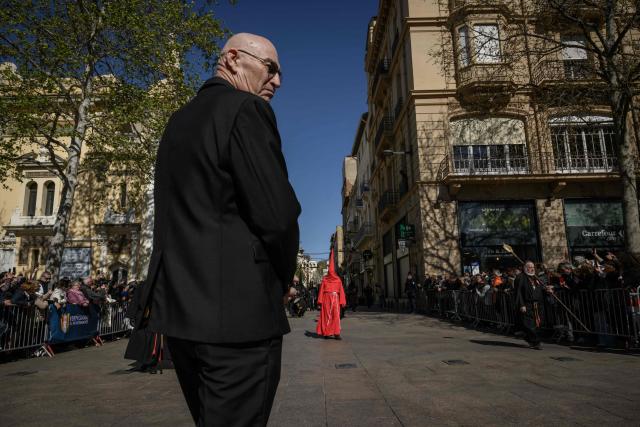 Penitants wearing caperuxta hoods take part in the Procession de la Sanch (Procession of Blood) in Perpignan on April 3, 2026. (Photo by Ed JONES / AFP)