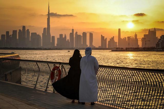 A couple stands looking at the Dubai skyline, with the Burj Khalifa, the world’s tallest building, seen from Creek Harbour on April 3, 2026. (Photo by FADEL SENNA / AFP)
