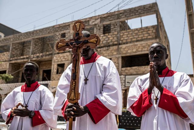 Christian worshippers take part in a Good Friday procession in Bakoteh, The Gambia, on April 3, 2026. (Photo by MUHAMADOU BITTAYE / AFP)