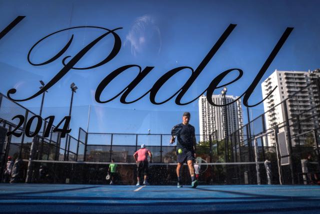 People play padel on a court in Miami, Florida, on March 22, 2026. Padel, the racket sport that originated among the elites of Latin America and Spain, has exploded in popularity in Miami. Fans say it will conquer the rest of the United States, and the world. (Photo by Giorgio Viera / AFP)