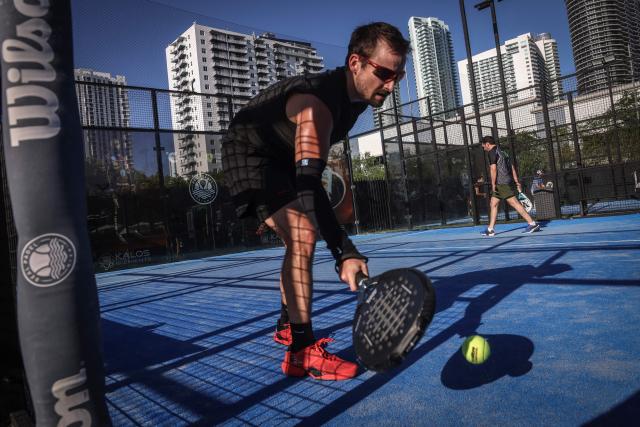 A person plays padel on a court in Miami, Florida, on March 22, 2026. Padel, the racket sport that originated among the elites of Latin America and Spain, has exploded in popularity in Miami. Fans say it will conquer the rest of the United States, and the world. (Photo by Giorgio Viera / AFP)