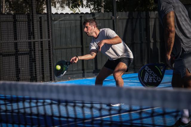 People play padel on a court in Miami, Florida, on March 22, 2026. Padel, the racket sport that originated among the elites of Latin America and Spain, has exploded in popularity in Miami. Fans say it will conquer the rest of the United States, and the world. (Photo by Giorgio Viera / AFP)