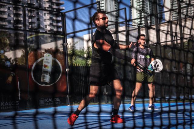 People play padel on a court in Miami, Florida, on March 22, 2026. Padel, the racket sport that originated among the elites of Latin America and Spain, has exploded in popularity in Miami. Fans say it will conquer the rest of the United States, and the world. (Photo by Giorgio Viera / AFP)