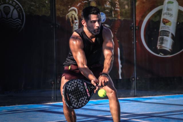 A person plays padel on a court in Miami, Florida, on March 22, 2026. Padel, the racket sport that originated among the elites of Latin America and Spain, has exploded in popularity in Miami. Fans say it will conquer the rest of the United States, and the world. (Photo by Giorgio Viera / AFP)