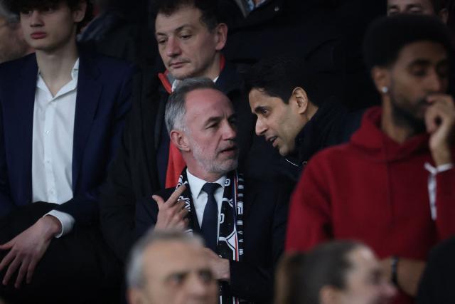 Paris' Mayor Emmanuel Gregoire (centre-L) speaks with Paris Saint Germain's Qatari president Nasser al-Khelaifi (centre-R) during the French L1 football match between Paris Saint-Germain (PSG) and Toulouse FC at the Parc des Princes stadium in Paris on April 3, 2026. (Photo by Anne-Christine POUJOULAT / AFP)