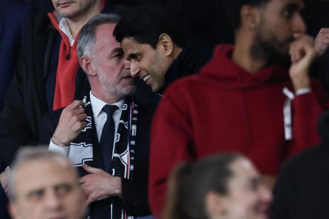 Paris' Mayor Emmanuel Gregoire (L) speaks with Paris Saint Germain's Qatari president Nasser al-Khelaifi during the French L1 football match between Paris Saint-Germain (PSG) and Toulouse FC at the Parc des Princes stadium in Paris on April 3, 2026. (Photo by Anne-Christine POUJOULAT / AFP)