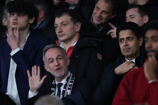 Paris' Mayor Emmanuel Gregoire (2nd L) waves flanked by Paris Saint Germain's Qatari president Nasser al-Khelaifi (R) during the French L1 football match between Paris Saint-Germain (PSG) and Toulouse FC at the Parc des Princes stadium in Paris on April 3, 2026. (Photo by Anne-Christine POUJOULAT / AFP)
