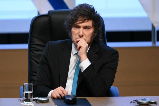 (FILES) Argentina's President Javier Milei gestures during the signing ceremony of the trade agreement between the European Union and Mercosur, at the Gran Teatro Jose Asuncion Flores of Paraguay's Central Bank in Asuncion on January 17, 2026. A network linked to Russian intelligence services launched a campaign against the government of Argentine President Javier Milei in 2024, according to a report published on April 2, 2026 by an international consortium of news organisations based on leaked documents. (Photo by Luis ROBAYO / AFP)