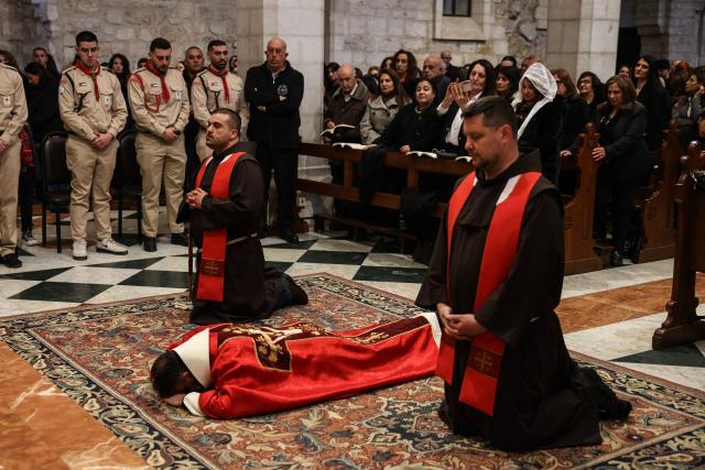 Palestinian Christian worshippers attend a Good Friday mass at the Catholic Church of Saint Catherine in the Israeli-occupied West Bank city of Bethlehem on April 3, 2026. (Photo by HAZEM BADER / AFP)