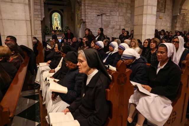 Nuns and Palestinian Christian worshippers attend a Good Friday mass at the Catholic Church of Saint Catherine in the Israeli-occupied West Bank city of Bethlehem on April 3, 2026. (Photo by HAZEM BADER / AFP)