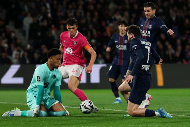 Toulouse's French goalkeeper #01 Guillaume Restes (L) stops the ball past Paris Saint-Germain's French defender #21 Lucas Hernandez (R) and Paris Saint-Germain's Georgian forward #07 Khvicha Kvaratskhelia (2nd R) during the French L1 football match between Paris Saint-Germain (PSG) and Toulouse FC at the Parc des Princes stadium in Paris on April 3, 2026. (Photo by Anne-Christine POUJOULAT / AFP)