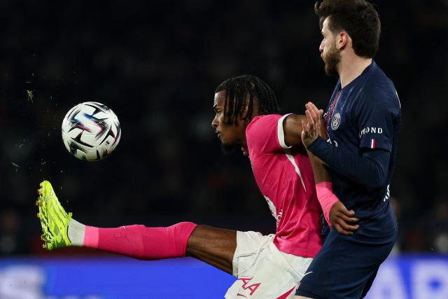 Toulouse's French forward #10 Yann Gboho (L) and Paris Saint-Germain's Georgian forward #07 Khvicha Kvaratskhelia fight for the ball during the French L1 football match between Paris Saint-Germain (PSG) and Toulouse FC at the Parc des Princes stadium in Paris on April 3, 2026. (Photo by Anne-Christine POUJOULAT / AFP)