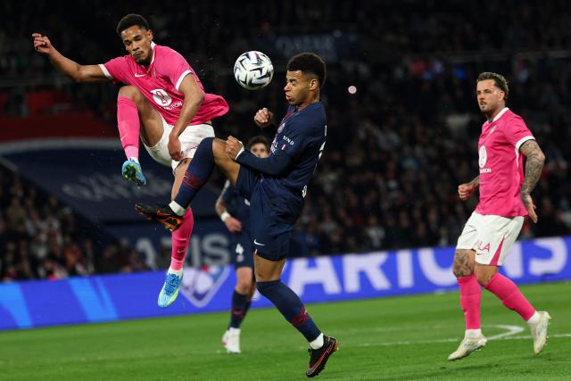 (From L) Toulouse's Brazilian forward #20 Emersonn and Paris Saint-Germain's French midfielder #14 Desire Doue fight for the ball during the French L1 football match between Paris Saint-Germain (PSG) and Toulouse FC at the Parc des Princes stadium in Paris on April 3, 2026. (Photo by Anne-Christine POUJOULAT / AFP)