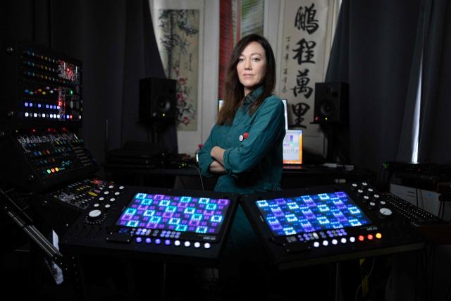 French producer-singer-songwriter of electronic music Cecile Leoge, aka DeLaurentis, poses in her music studio at home during a photo session in Paris, on March 31, 2026. (Photo by JOEL SAGET / AFP)