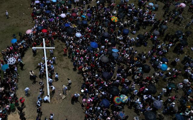Aerial view of catholic faithfuls carrying a cross during the Via Crucis procession as part of Good Friday celebrations at the Tree of Life in Ciudad Bolivar, south Bogota on April 3, 2026. (Photo by Raul ARBOLEDA / AFP)