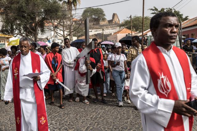 A young man carries a cross as he portrays Jesus Christ during a Good Friday Way of the Cross procession in Cidade Velha, Cape Verde, on April 3, 2026. The city was founded in 1462 by Portuguese traders and was the first colonial outpost in the tropics. Formerly known as Ribeira Grande, the town has a rich historical heritage including Our Lady of the Rosary, a church built in 1495 by Portuguese settlers. The town became a UNESCO World Heritage Site in 2009. (Photo by PATRICK MEINHARDT / AFP)