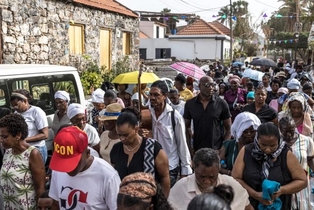 Christian parishioners take part in a Good Friday Way of the Cross procession in Cidade Velha, Cape Verde, on April 3, 2026. The city was founded in 1462 by Portuguese traders and was the first colonial outpost in the tropics. Formerly known as Ribeira Grande, the town has a rich historical heritage including Our Lady of the Rosary, a church built in 1495 by Portuguese settlers. The town became a UNESCO World Heritage Site in 2009. (Photo by PATRICK MEINHARDT / AFP)
