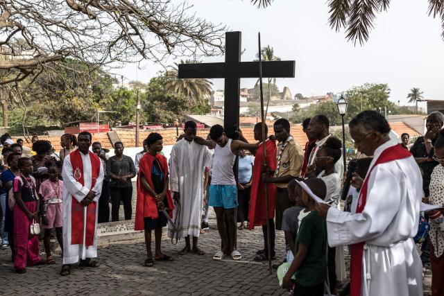 Christian parishioners reenact the crucifixion of Jesus Christ during a Good Friday Way of the Cross procession at Our Lady of the Rosary church in Cidade Velha, Cape Verde, on April 3, 2026. The city was founded in 1462 by Portuguese traders and was the first colonial outpost in the tropics. Formerly known as Ribeira Grande, the town has a rich historical heritage including Our Lady of the Rosary, a church built in 1495 by Portuguese settlers. The town became a UNESCO World Heritage Site in 2009. (Photo by PATRICK MEINHARDT / AFP)