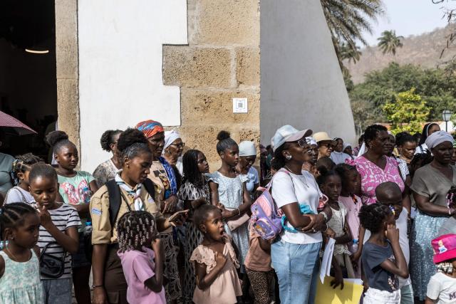 Christian parishioners watch the reenactment of the crucifixion of Jesus Christ during a Good Friday Way of the Cross procession at Our Lady of the Rosary church in Cidade Velha, Cape Verde, on April 3, 2026. The city was founded in 1462 by Portuguese traders and was the first colonial outpost in the tropics. Formerly known as Ribeira Grande, the town has a rich historical heritage including Our Lady of the Rosary, a church built in 1495 by Portuguese settlers. The town became a UNESCO World Heritage Site in 2009. (Photo by PATRICK MEINHARDT / AFP)