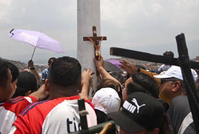 Catholic faithfuls attend the Via Crucis procession as part of Good Friday celebrations at the Tree of Life in Ciudad Bolivar, south Bogota on April 3, 2026. (Photo by Raul ARBOLEDA / AFP)