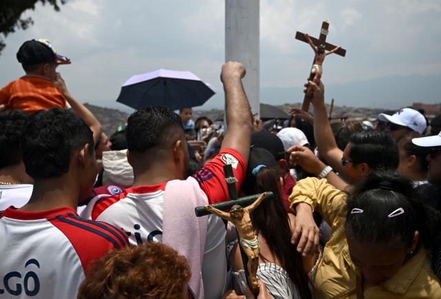 Catholic faithfuls attend the Via Crucis procession as part of Good Friday celebrations at the Tree of Life in Ciudad Bolivar, south Bogota on April 3, 2026. (Photo by Raul ARBOLEDA / AFP)