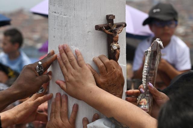 Catholic faithfuls attend the Via Crucis procession as part of Good Friday celebrations at the Tree of Life in Ciudad Bolivar, south Bogota on April 3, 2026. (Photo by Raul ARBOLEDA / AFP)