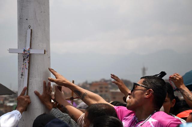 Catholic faithfuls attend the Via Crucis procession as part of Good Friday celebrations at the Tree of Life in Ciudad Bolivar, south Bogota on April 3, 2026. (Photo by Raul ARBOLEDA / AFP)