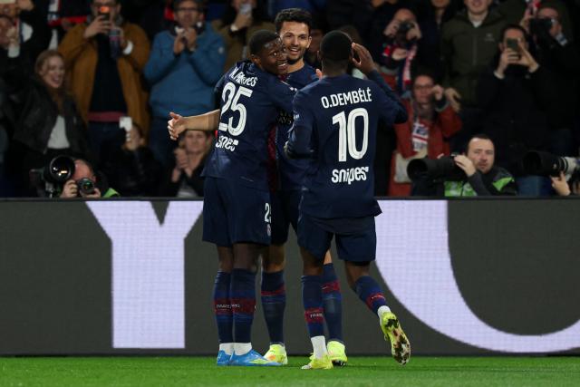 Paris Saint-Germain's Portuguese forward #09 Goncalo Ramos (c) celebrates with teammates Paris Saint-Germain's Portuguese defender #25 Nuno Mendes and Paris Saint-Germain's French forward #10 Ousmane Dembele after scoring his team's third goal during the French L1 football match between Paris Saint-Germain (PSG) and Toulouse FC at the Parc des Princes stadium in Paris on April 3, 2026. (Photo by Anne-Christine POUJOULAT / AFP)