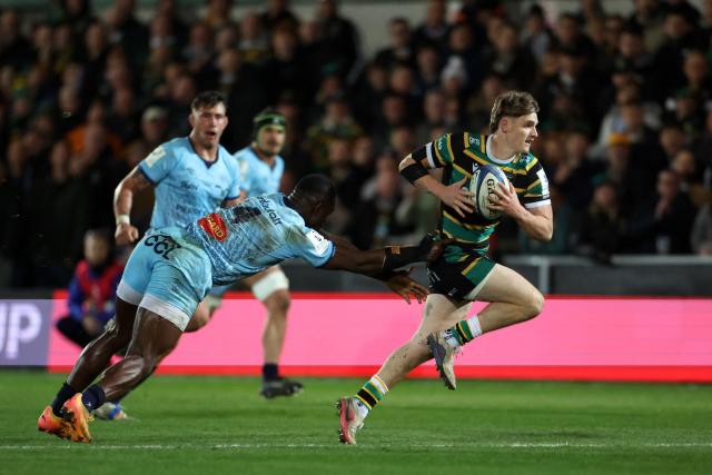 Northampton Saints' French scrum half Archie McParland runs to score the team's sixth try past Castres' French lock Guillaume Ducat during the European Rugby Champions Cup round of 16 rugby union match, between Northampton Saints and Castres Olympique at Franklin's Gardens in Northampton, central England, on April 3, 2026. (Photo by Darren Staples / AFP)