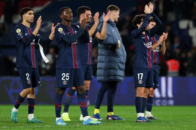 Paris Saint-Germain's players celebrate after winning the French L1 football match between Paris Saint-Germain (PSG) and Toulouse FC at the Parc des Princes stadium in Paris on April 3, 2026. (Photo by Anne-Christine POUJOULAT / AFP)
