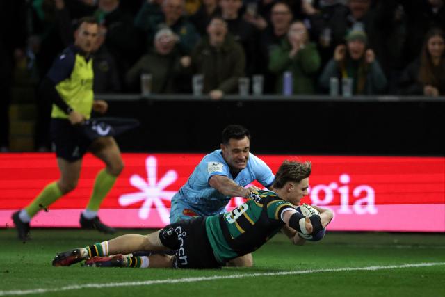 Northampton Saints' French scrum half Archie McParland scores the team's sixth try past Castres' French wing Geoffrey Palis during the European Rugby Champions Cup round of 16 rugby union match, between Northampton Saints and Castres Olympique at Franklin's Gardens in Northampton, central England, on April 3, 2026. (Photo by Darren Staples / AFP)