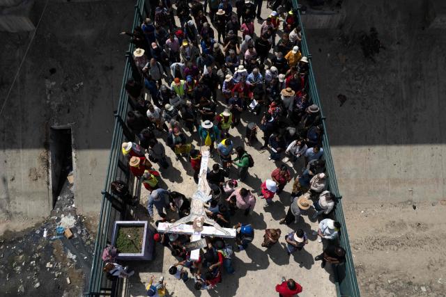 This aerial view shows Catholic faithful, migrants, and advocates participating in the Migrant Walk of the Cross as part of the Holy Week celebrations in Tijuana, Baja California state, Mexico on April 3, 2026. (Photo by Guillermo Arias / AFP)