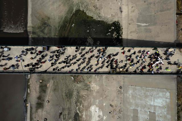This aerial view shows Catholic faithful, migrants, and advocates participating in the Migrant Walk of the Cross as part of the Holy Week celebrations in Tijuana, Baja California state, Mexico on April 3, 2026. (Photo by Guillermo Arias / AFP)