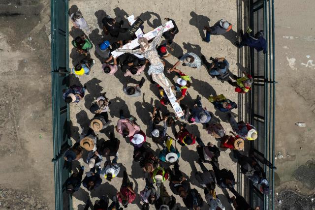 This aerial view shows Catholic faithful, migrants, and advocates participating in the Migrant Walk of the Cross as part of the Holy Week celebrations in Tijuana, Baja California state, Mexico on April 3, 2026. (Photo by Guillermo Arias / AFP)