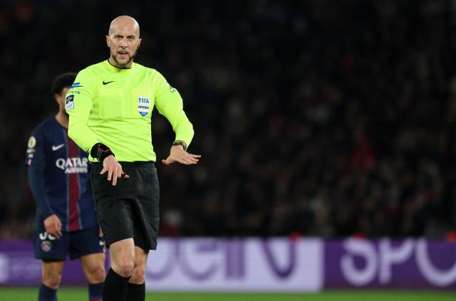 French referee Eric Wattellier gestures during the French L1 football match between Paris Saint-Germain (PSG) and Toulouse FC at the Parc des Princes stadium in Paris on April 3, 2026. (Photo by Anne-Christine POUJOULAT / AFP)