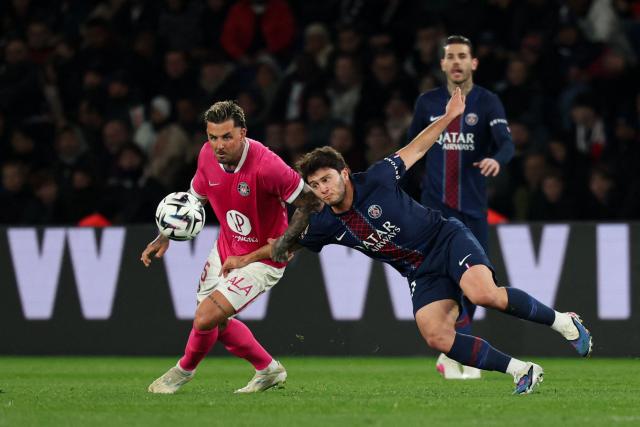 Toulouse's Norwegian midfielder #15 Aron Donnum (L) and Paris Saint-Germain's Portuguese midfielder #87 Joao Pedro Goncalves Neves fight for the ball during the French L1 football match between Paris Saint-Germain (PSG) and Toulouse FC at the Parc des Princes stadium in Paris on April 3, 2026. (Photo by Anne-Christine POUJOULAT / AFP)