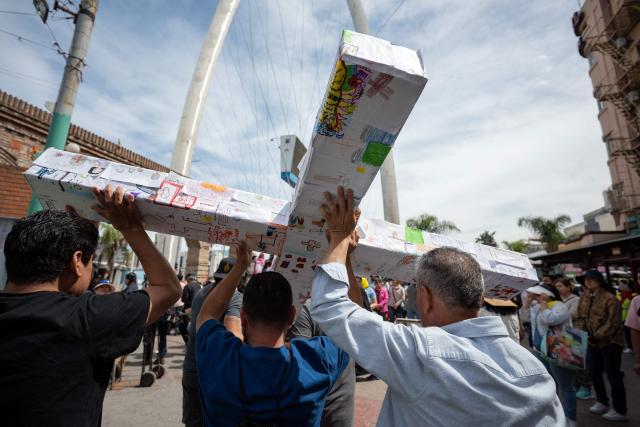 Migrants and advocates participate in the Migrant Walk of the Cross as part of the Holy Week celebrations in Tijuana, Baja California state, Mexico, on April 3, 2026. (Photo by Guillermo Arias / AFP)