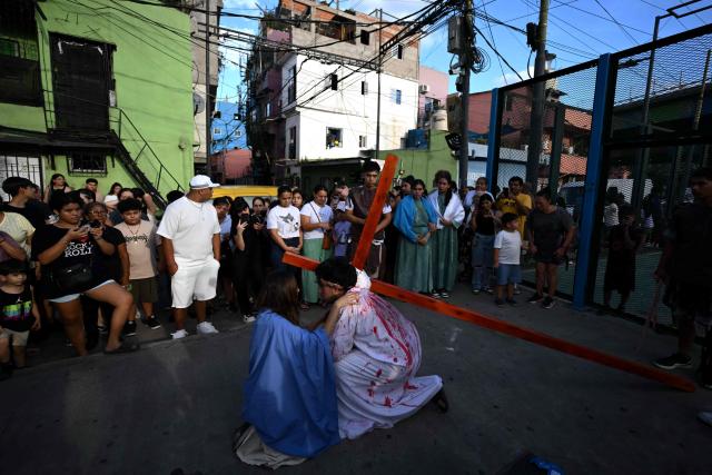 Youngsters enact the Passion of Jesus Christ during a procession marking the Way of the Cross on Good Friday at the Padre Carlos Mujica shantytown (known as Villa 31) in Buenos Aires on April 3, 2026. (Photo by Luis ROBAYO / AFP)