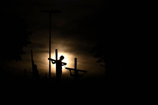 Youngsters enact the Passion of Jesus Christ during a procession marking the Way of the Cross on Good Friday at the Padre Carlos Mujica shantytown (known as Villa 31) in Buenos Aires on April 3, 2026. (Photo by Luis ROBAYO / AFP)