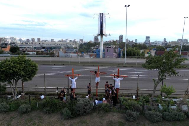Youngsters enact the Passion of Jesus Christ during a procession marking the Way of the Cross on Good Friday at the Padre Carlos Mujica shantytown (known as Villa 31) in Buenos Aires on April 3, 2026. (Photo by Luis ROBAYO / AFP)