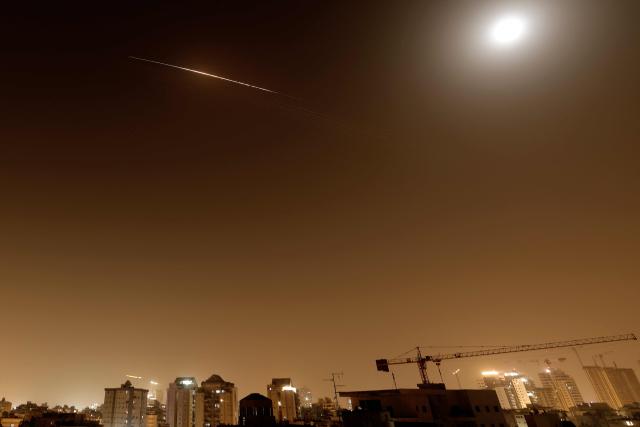 Rocket trails are seen in the sky above the Netanya, Israel, on April 4, 2026. (Photo by JACK GUEZ / AFP)