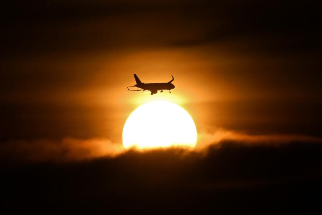 An airplane prepares to land at the El Dorado International Airport during a cloudy sunset in Bogota on April 3, 2026. (Photo by Pablo VERA / AFP)