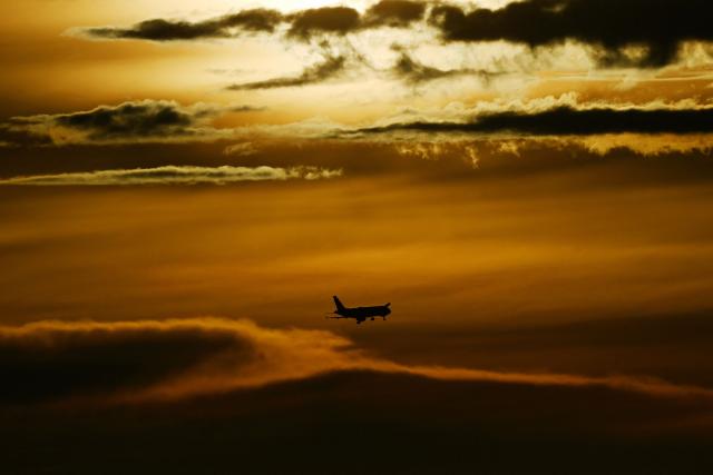An airplane prepares to land at the El Dorado International Airport during a cloudy sunset in Bogota on April 3, 2026. (Photo by Pablo VERA / AFP)