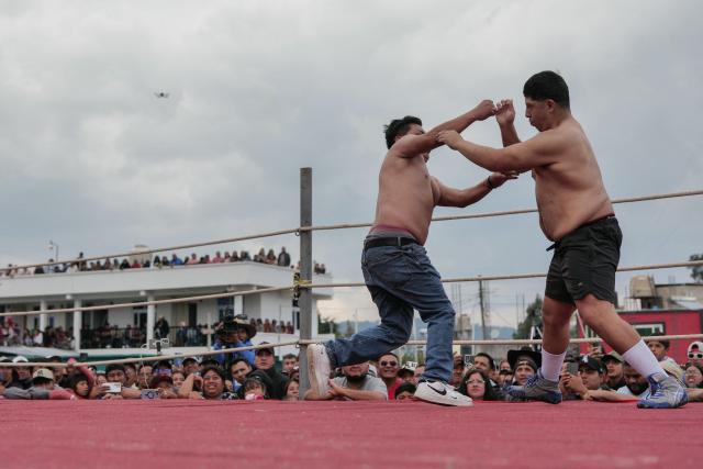 Competitors fight during a traditional boxing tournament which commemorates Good Friday and the crucifixion of Jesus in Chivarreto, Totonicapan department, 205 km west of Guatemala City, on April 3, 2026.  (Photo by Edwin BERCIAN / AFP)