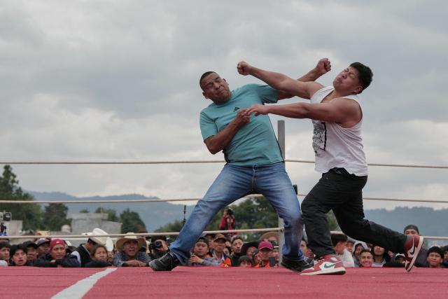 Competitors fight during a traditional boxing tournament which commemorates Good Friday and the crucifixion of Jesus in Chivarreto, Totonicapan department, 205 km west of Guatemala City, on April 3, 2026.  (Photo by Edwin BERCIAN / AFP)