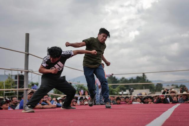 Competitors fight during a traditional boxing tournament which commemorates Good Friday and the crucifixion of Jesus in Chivarreto, Totonicapan department, 205 km west of Guatemala City, on April 3, 2026.  (Photo by Edwin BERCIAN / AFP)