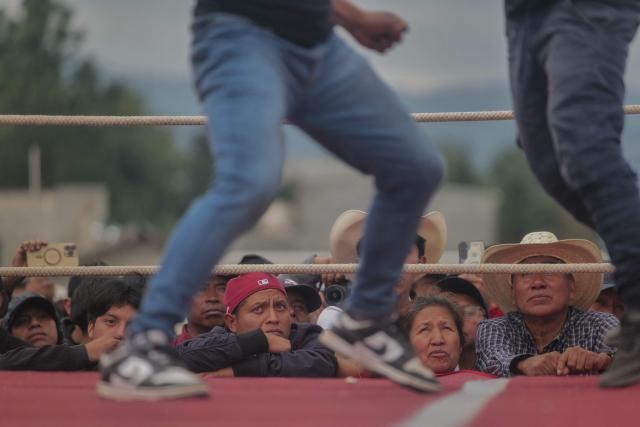 Spectators watch as competitors fight during a traditional boxing tournament which commemorates Good Friday and the crucifixion of Jesus in Chivarreto, Totonicapan department, 205 km west of Guatemala City, on April 3, 2026.  (Photo by Edwin BERCIAN / AFP)