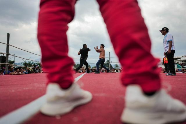 Competitors fight during a traditional boxing tournament which commemorates Good Friday and the crucifixion of Jesus in Chivarreto, Totonicapan department, 205 km west of Guatemala City, on April 3, 2026.  (Photo by Edwin BERCIAN / AFP)