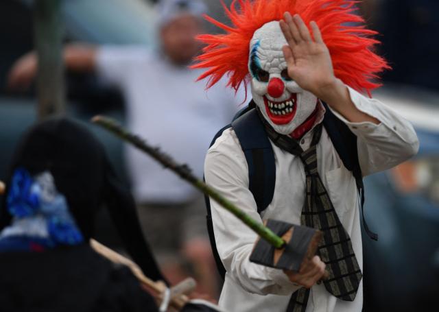 A masked resident fights with a sword as part of a tradition after the Good Friday procession in Petoa, Santa Barbara department, Honduras, on April 3, 2026. (Photo by Orlando SIERRA / AFP)